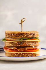 Canvas Print - Ham, vegetables and cheese sandwiches on a white plate, white background.