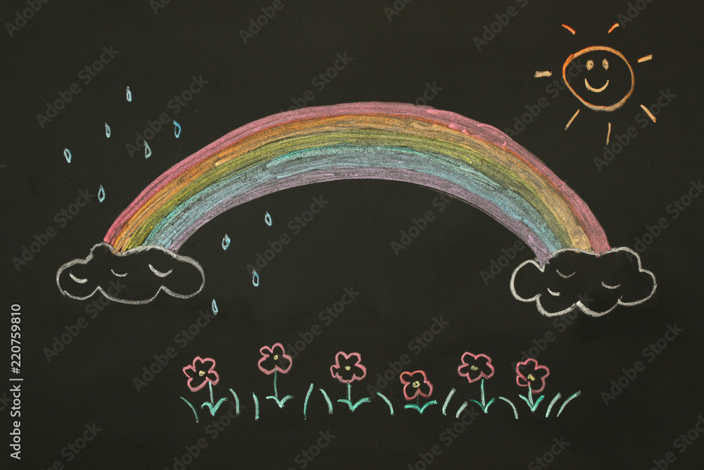 Actual drawing on black chalk board. Colorful rainbow on clouds with ...