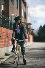 Wall Mural - Portrait of beautiful brunette with bicycle.