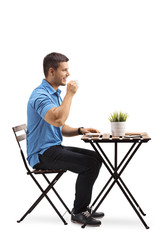 Poster - Young man drinking coffee isolated on white background