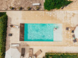top view of girlfriend and boyfriend resting at swimming pool near villa in Italy