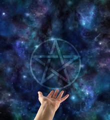 Wall Mural - presenting the pentacle - transparent pentacle symbol floating above open palm hand against a dark b