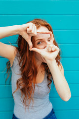 Creative young woman making a frame gesture