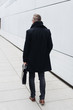 © contrastwerkstatt - Rear view of man walking with briefcase