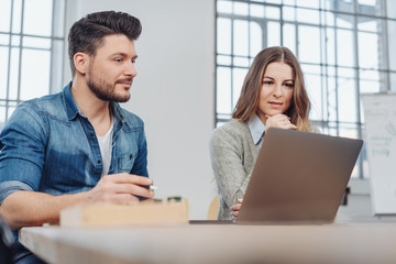 Two young business people working on a problem