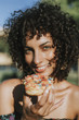 © Rawpixel.com - Beautiful woman eating a doughnut