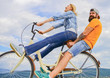 © be free - Man and woman rent bike to discover city. Bike rental or bike hire for short periods of time. Couple with bicycle romantic date sky background. Couple in love date outdoors cycling. Date ideas