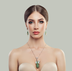 Wall Mural - Perfect woman with fashion jewelry portrait. Jewelry for woman, necklace and earrings with pearls and green stones