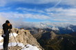 © Dmitry - A photographer takes a beautiful view from the top of the mountain