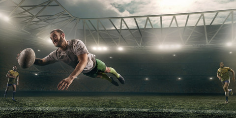 Wall Mural - Dirty rugby player catch the ball in flight on professional rugby stadium