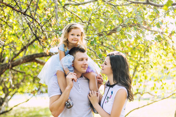 Family mother, father and daughter happy and beautiful with smiles portrait in nature