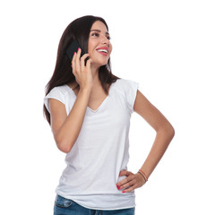 Wall Mural - beautiful woman talking on the phone looks up to side