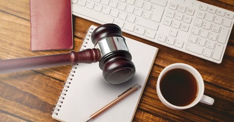 Canvas Print - Gavel and keyboard with notepads and coffee on desk