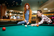 © NDABCREATIVITY - Beautiful women playing billiards