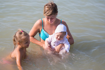 Wall Mural - Mom with two children at sea