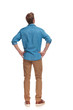 back view of a casual man with hands on waist