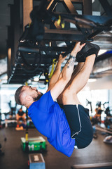 Wall Mural - Man pulling his body up on the rig at the gym.