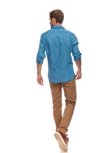 Back View Of  Casual Man Walking And Looking To Side