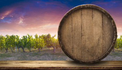 Red wine with barrel on vineyard in green Tuscany, Italy