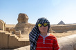 A boy in keffiyeh left alone near Sphinx, Giza, Egypt.