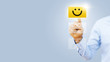 © sichon - Hand of client show a feedback with smiley face card. Service rating, satisfaction concept
