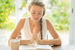 © PhotoGranary - Christian worship and praise. A young woman is reading the Bible and praying in the early morning