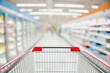 © Kwangmoozaa - Supermarket aisle blur defocused background with empty red shopping cart