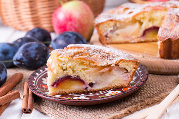 Delicious cake with plums and apples