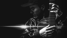 Black And White Portrait Of Asian Handsome Male Musician Posing On Acoustic Guitar