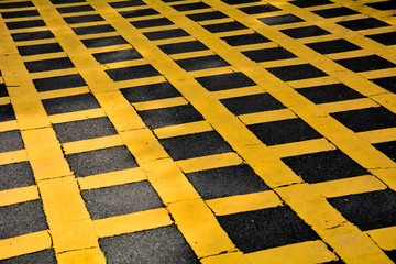 Yellow table symbol on asphalt road in urban