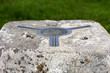 The brass plate used as a mounting point for a theodolite on top of a concrete British Ordnance Survey triangulation point, or Trig Point