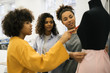 © Oleksii - Creative team of cheerful fashion designer, tailor and dressmaker working together in tailor shop.Beautiful African American students learning fashion design, discussion project at atelier. Teamwork.