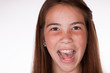© kmlPhoto - Close up shot of Cute Tween Brunette girl in studio with slight faded film look with mouth open being silly