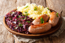 Traditional German Sausages With Mashed Potato And Sauerkraut. Wurst Or Bratwurst With Red Cabbage Close-up On A Plate. Horizontal