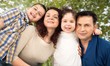 © BillionPhotos.com - Happy smiling family with daughter over green trees background