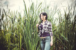 © T.Den_Team - Portrait of country style of the young beautiful girl in a plaid shirt and jeans. American style, fashionable modern trend
