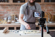 © golubovy - vlogging and freelance job concept. food blogger preparing blueberry pie. cooking and culinary skills concept. bearded man shooting video of himself using camera on tripod.