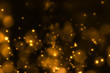 christmas gold gradient sparkle glitter dust particles on black background with bokeh flowing movement, golden holiday happy new year and valentine day love, relationship concept