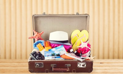 Wall Mural - Travel bag on wooden floor and blue wall background