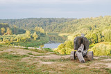Fototapeta Do pokoju - An old wooden cannon as decoration stands against a beautiful landscape with the river Ugra