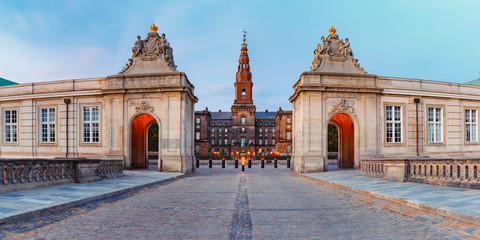 The main entrance to Christiansborg with the two Rococo pavilions on each side of the Marble Bridge during morning blue hour, Copenhagen, capital of Denmark