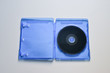 © Vladyslav - Blu-ray disc in the blue box on white background. Top view