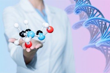 Wall Mural - Close up of Molecular structure model in hand on background