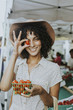 © Rawpixel.com - Beautiful woman buying tomatoes at a farmers market