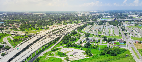 Panorama aerial view highway 90 (U.S. Route 90, US-90) and elevated Westbank expressway in suburban New Orleans, Louisiana. Massive intersection, stack interchange, road junction overpass with traffic