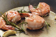 king prawns roasted with rosemary and garlic in an iron pan, food and cokking concept, close up