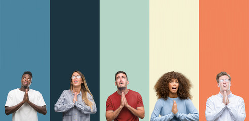 Canvas Print - Group of people over vintage colors background begging and praying with hands together with hope expression on face very emotional and worried. Asking for forgiveness. Religion concept.