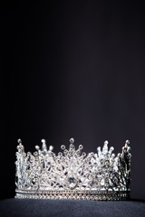 Wall Mural - Diamond Silver Crown for Miss Pageant Beauty queen Contest, Crystal Tiara jewelry decorated gems stone and abstract dark background on black velvet fabric cloth, Macro photography copy space