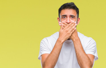 Canvas Print - Adult hispanic man over isolated background shocked covering mouth with hands for mistake. Secret concept.