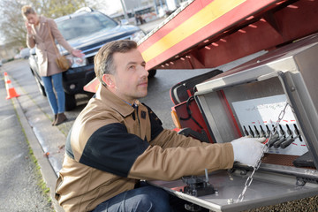 man towing car on his tow truck